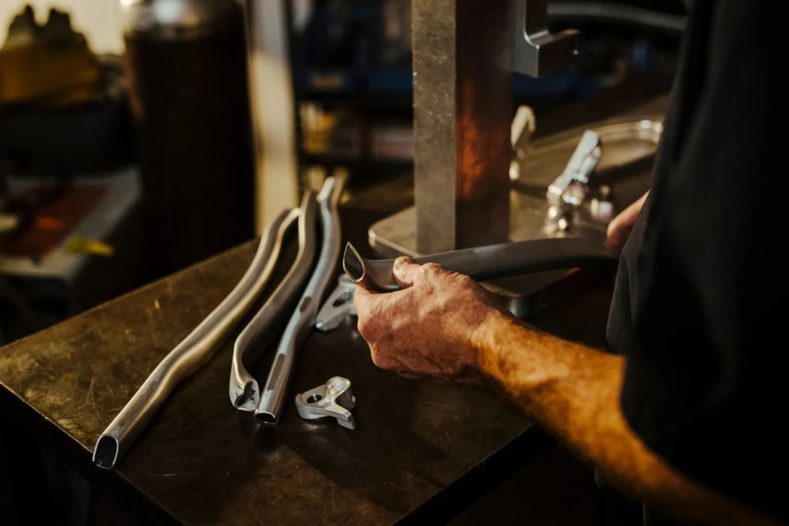 man looking at frame tubes