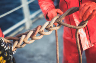 Fisherman ties the cod end of the net