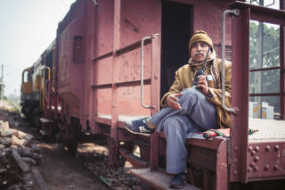 Railway attendant sat on outside of train, Allahabad