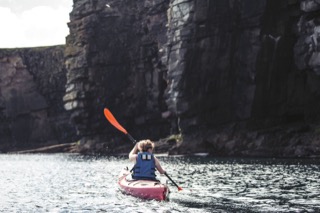 Kayaker below cliffs, Boddam