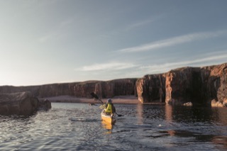Kayaker below cliffs, Braewick