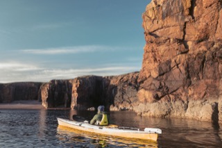 Kayaker below cliffs, Braewick