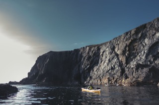 Kayaker below cliffs, Hillswick Ness
