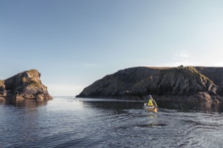 Kayaker below cliffs, Hillswick Ness