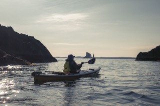 Kayaker with view of the Drongs, Hillswick Ness