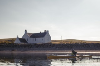 Kayaker leaving Hillswick Bay