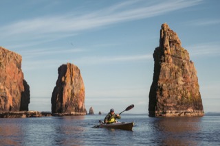Kayaker among sea stacks, Braewick