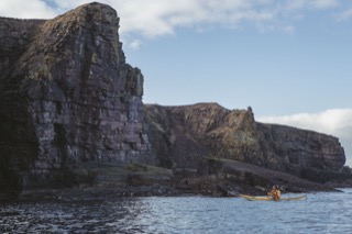 Kayaker below Brindister cliffs