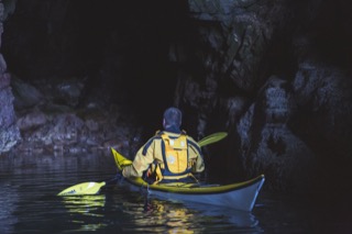 Kayaker in cave, Brindister cliffs