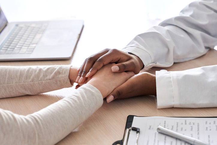 doctor holding her patient's hands