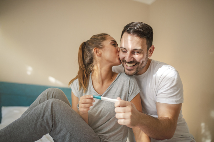 couple celebrating the results of a pregnancy test