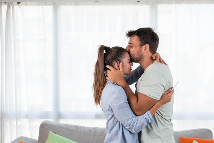 couple celebrating positive pregnancy test results