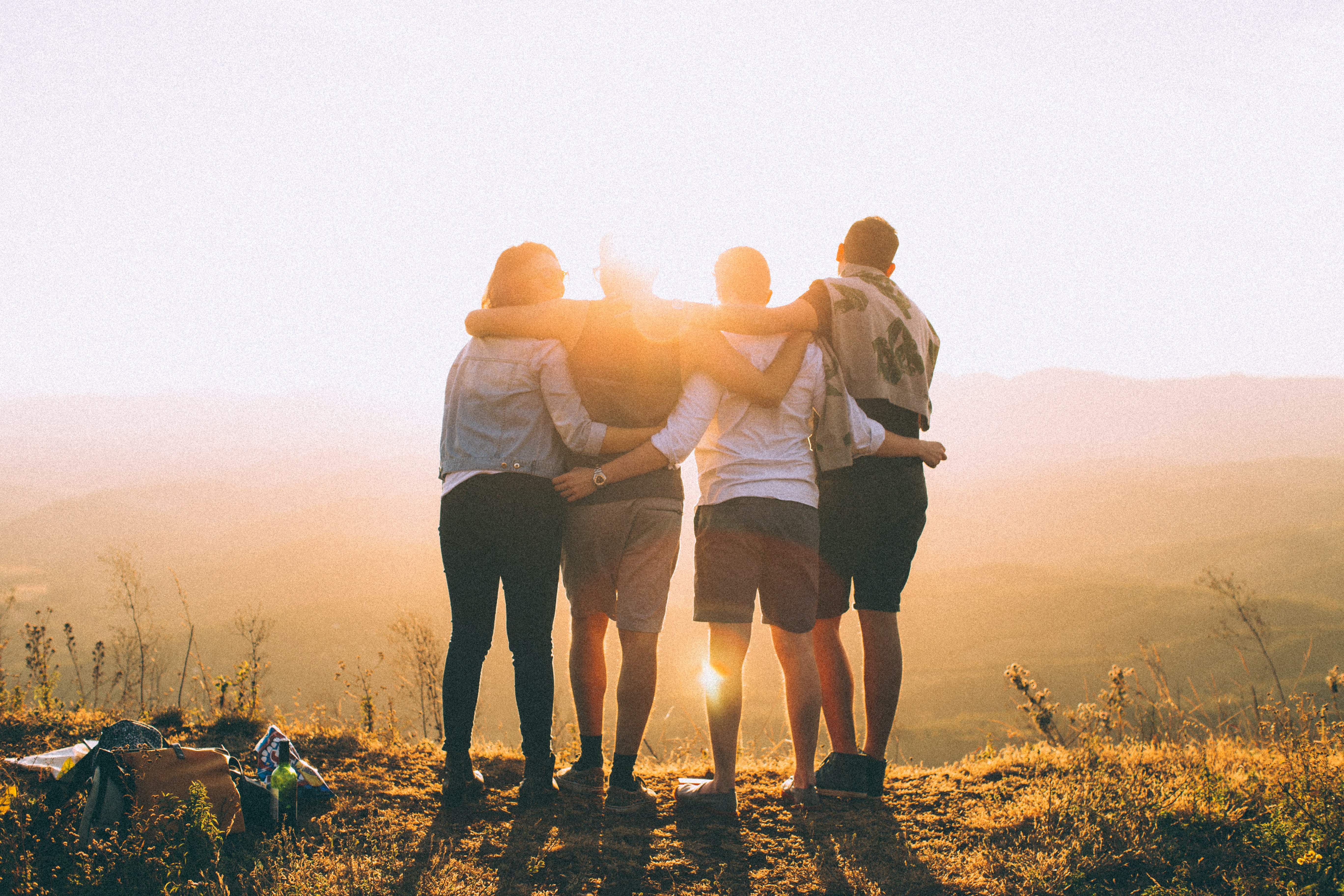 four friends enjoying sunset