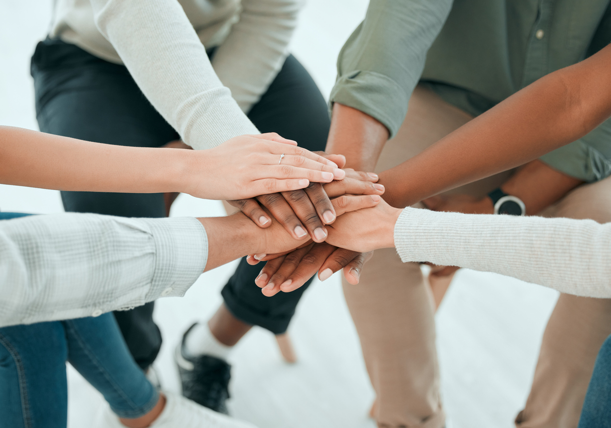 women stacking hands in solidarity