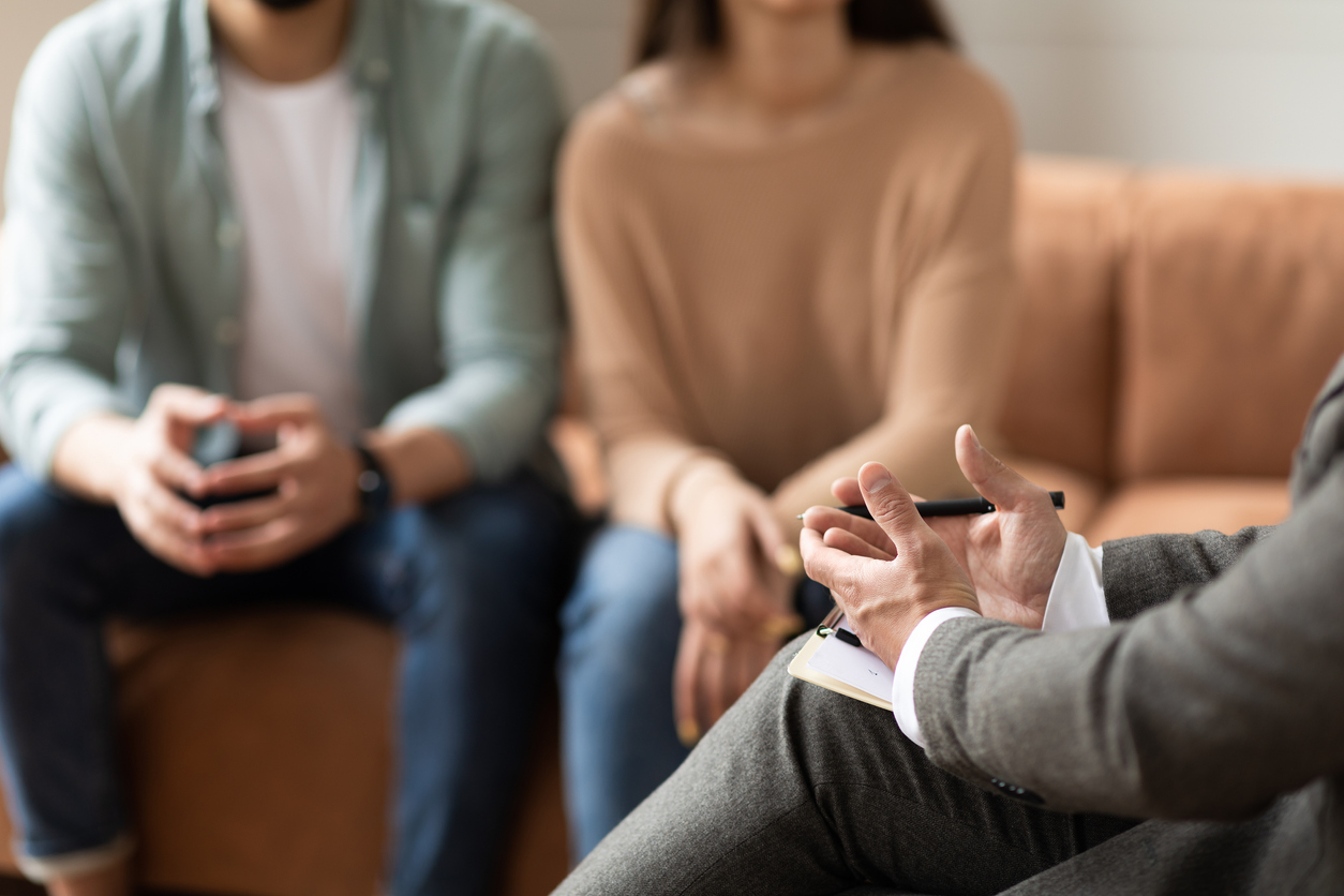 couple meeting discussing genetic testing with a fertility doctor