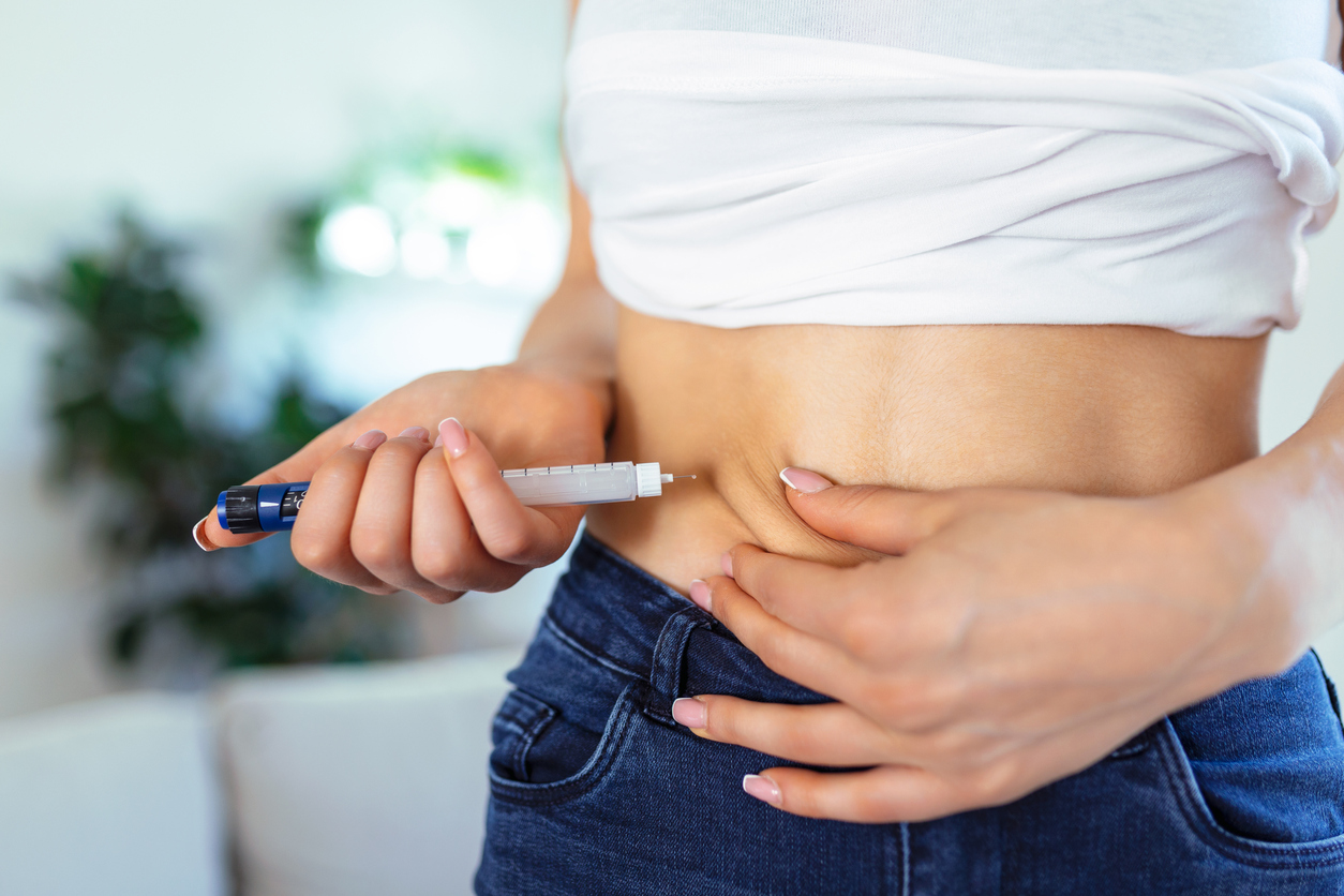 woman giving herself an ivf injection