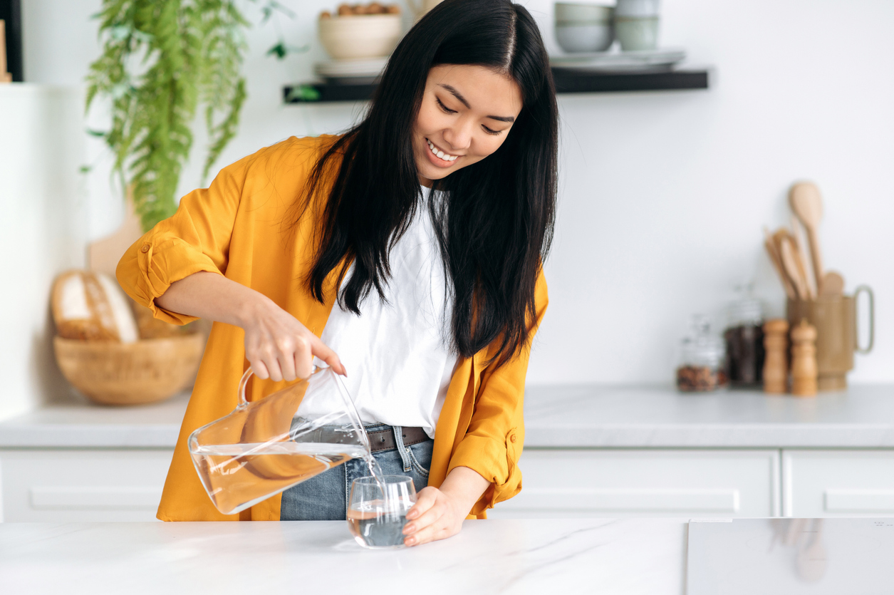 woman pouring glass of water