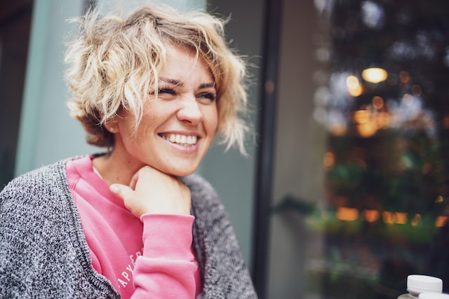 seated woman smiling in an urban environment