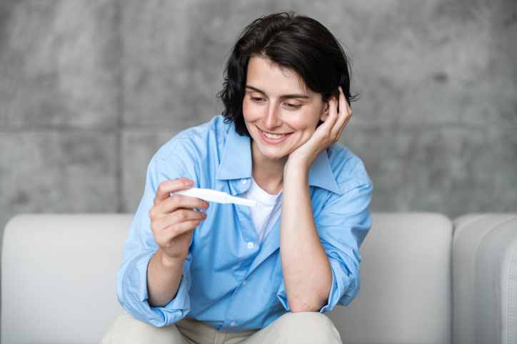 woman looking at a pregnancy test