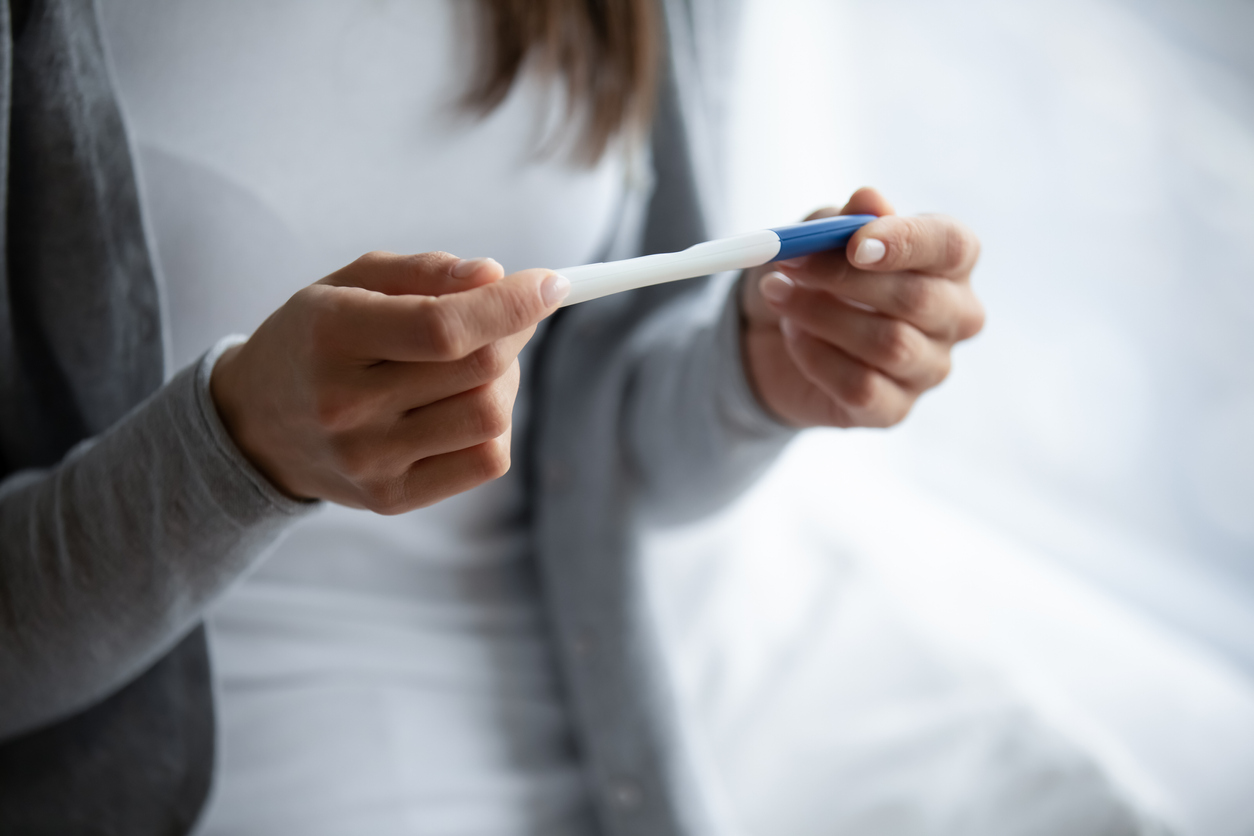 woman looking at pregnancy test