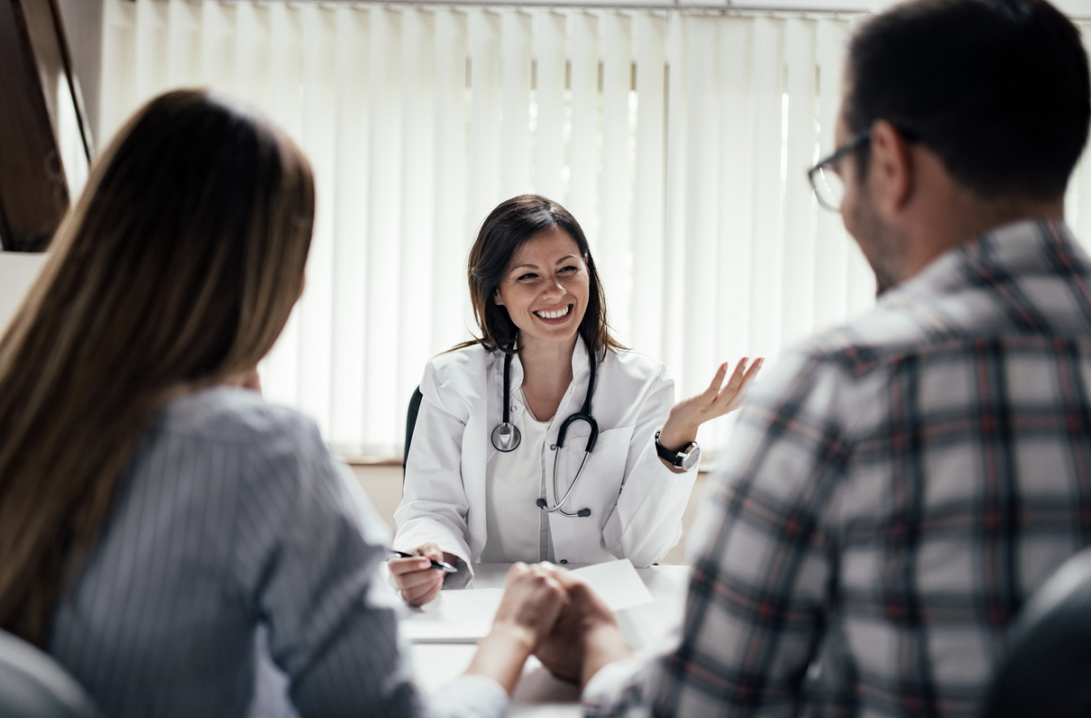 doctor discussing male fertility factor with a couple