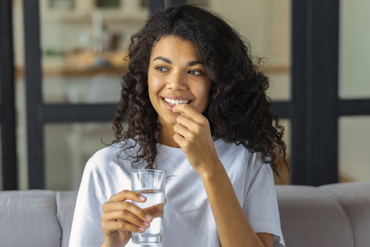 woman taking a probiotic