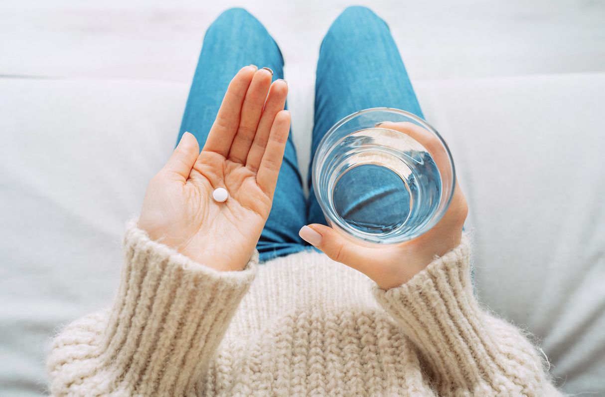 woman taking pain medication for an endo flare up