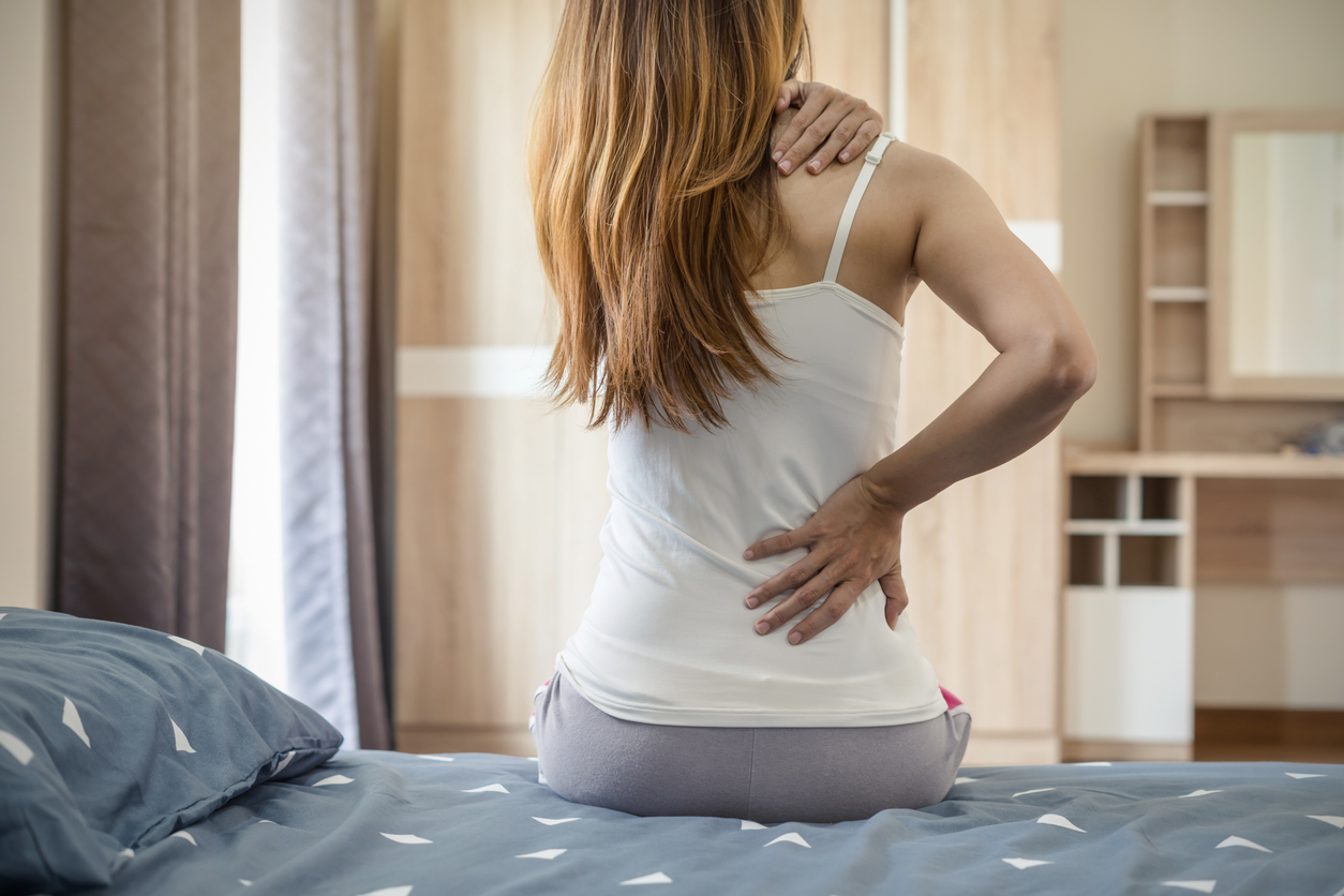 woman with back pain due to ovarian cysts