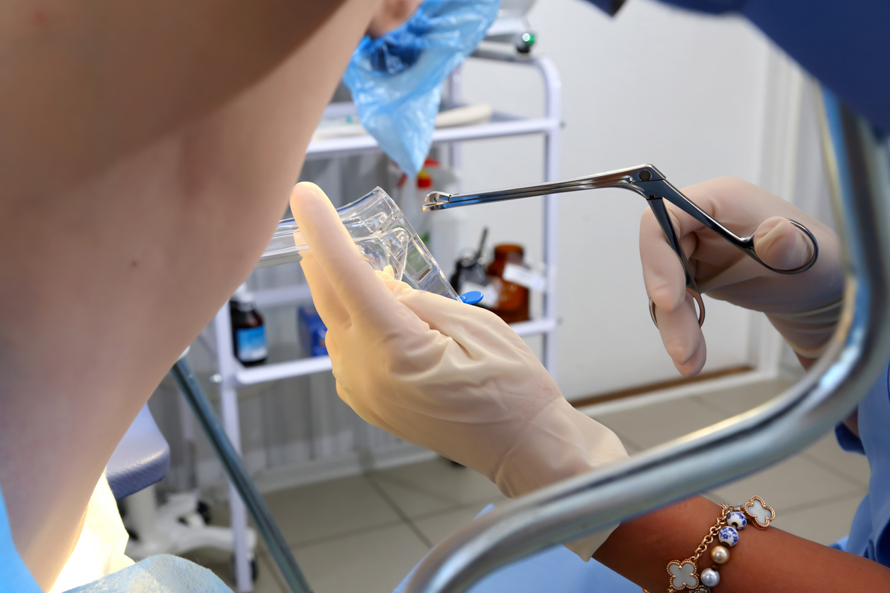 doctor using a speculum during a pap test