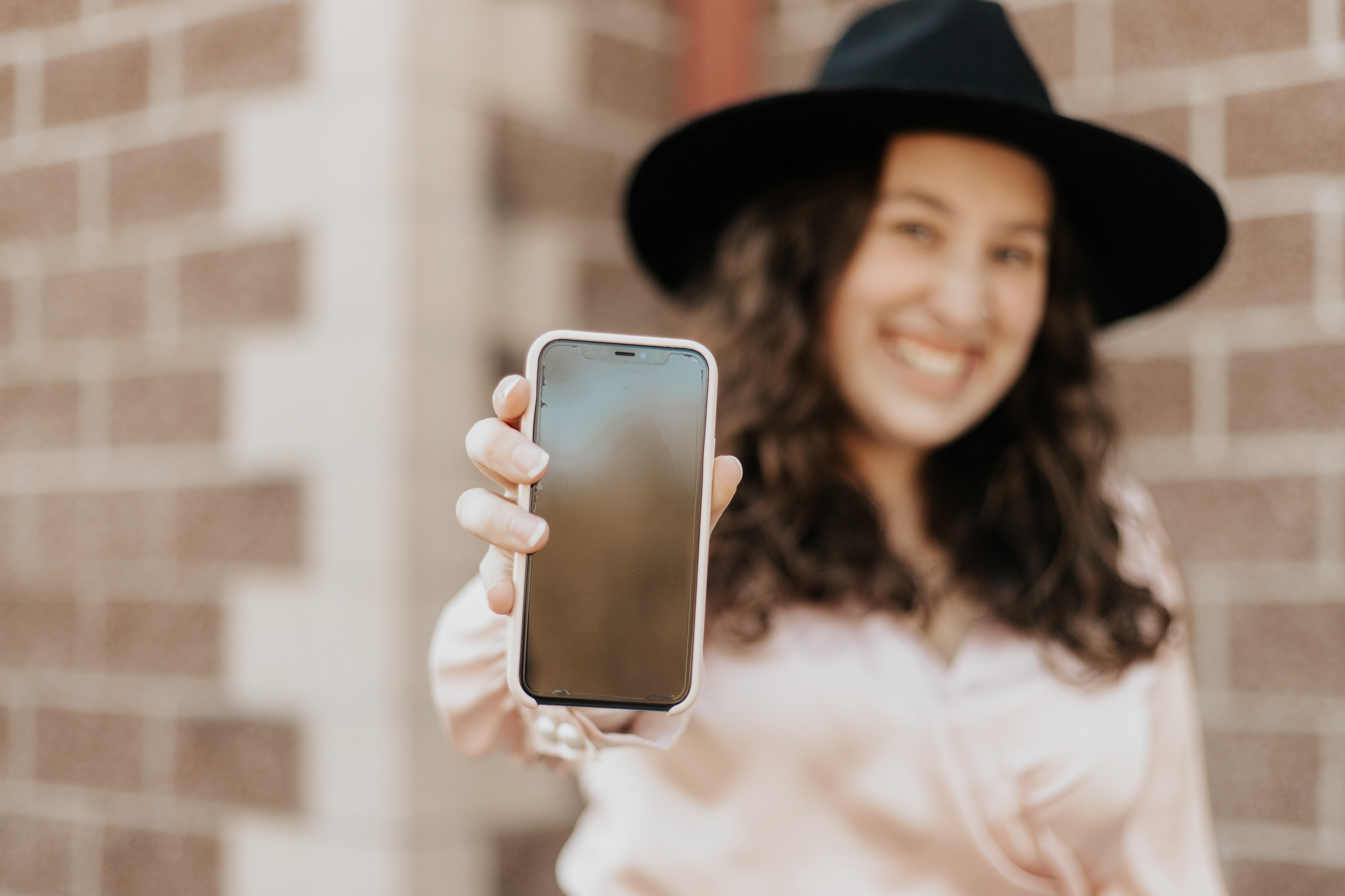 woman holding her phone up for all to see