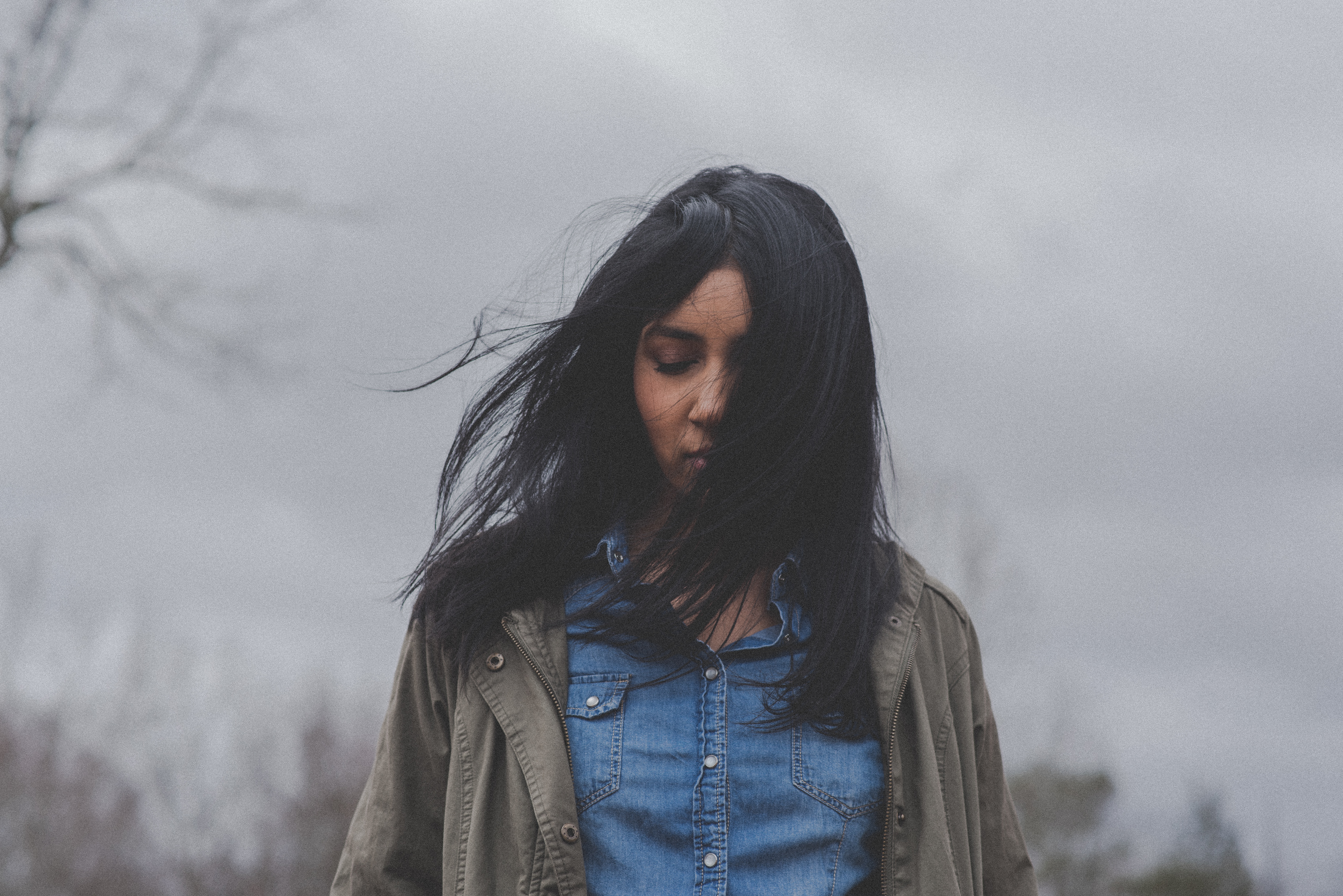 woman in distress under a grey sky