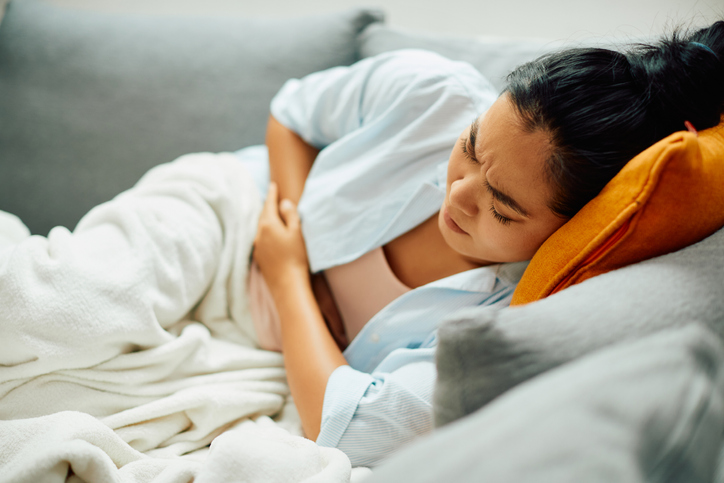 woman in bed with endometriosis pain