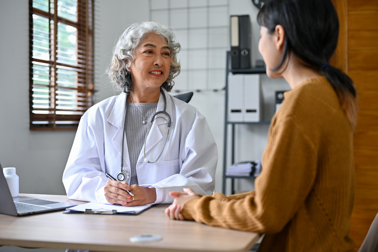 woman discussing postpartum recovery with her obgyn