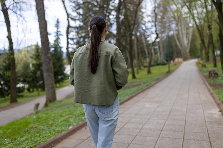 woman walking through a park