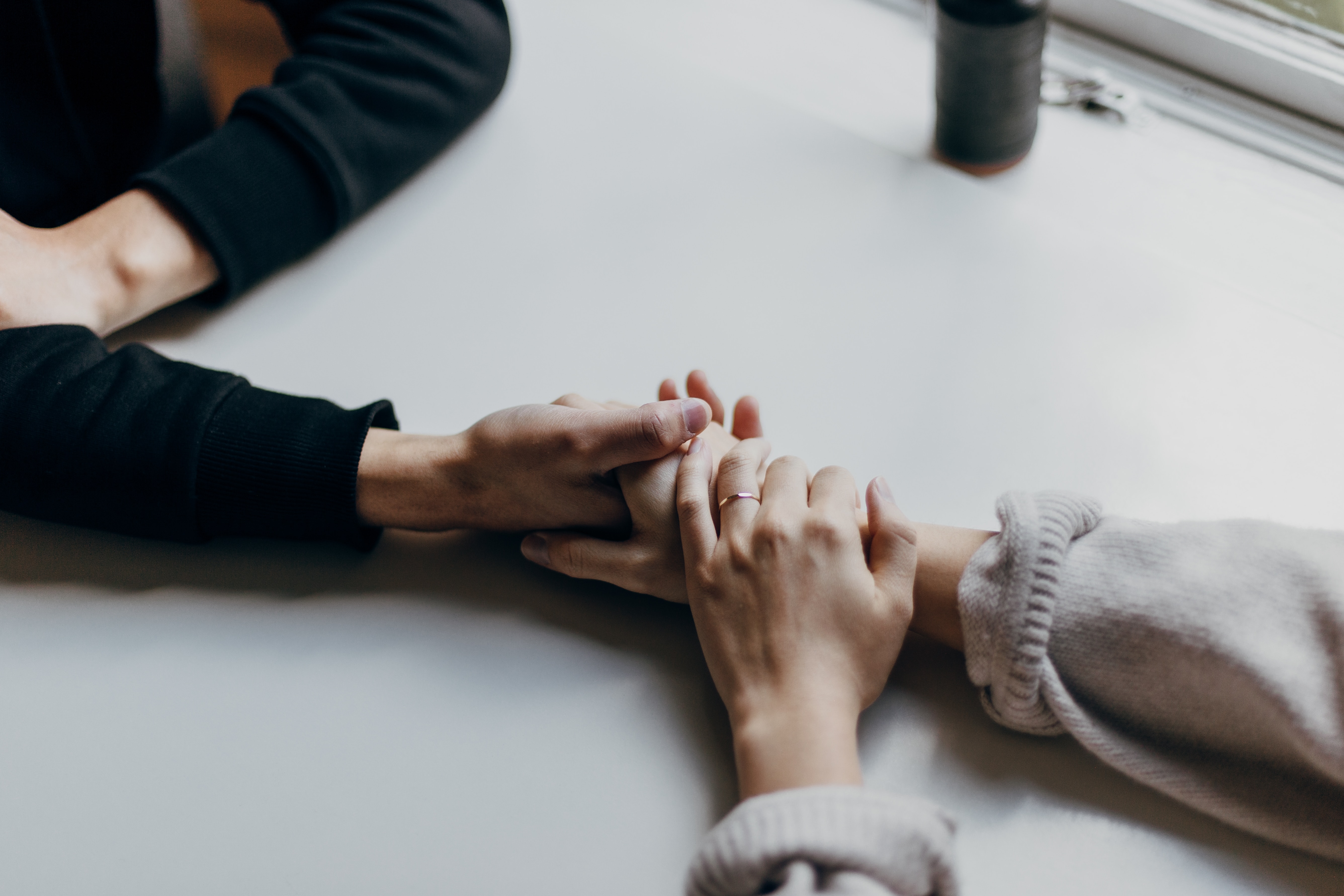 people holding hands in support