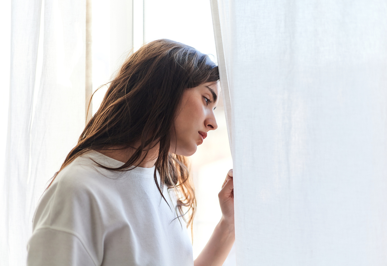 woman staring out a window