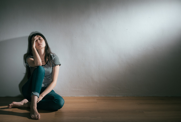 woman in distress sitting on the floor