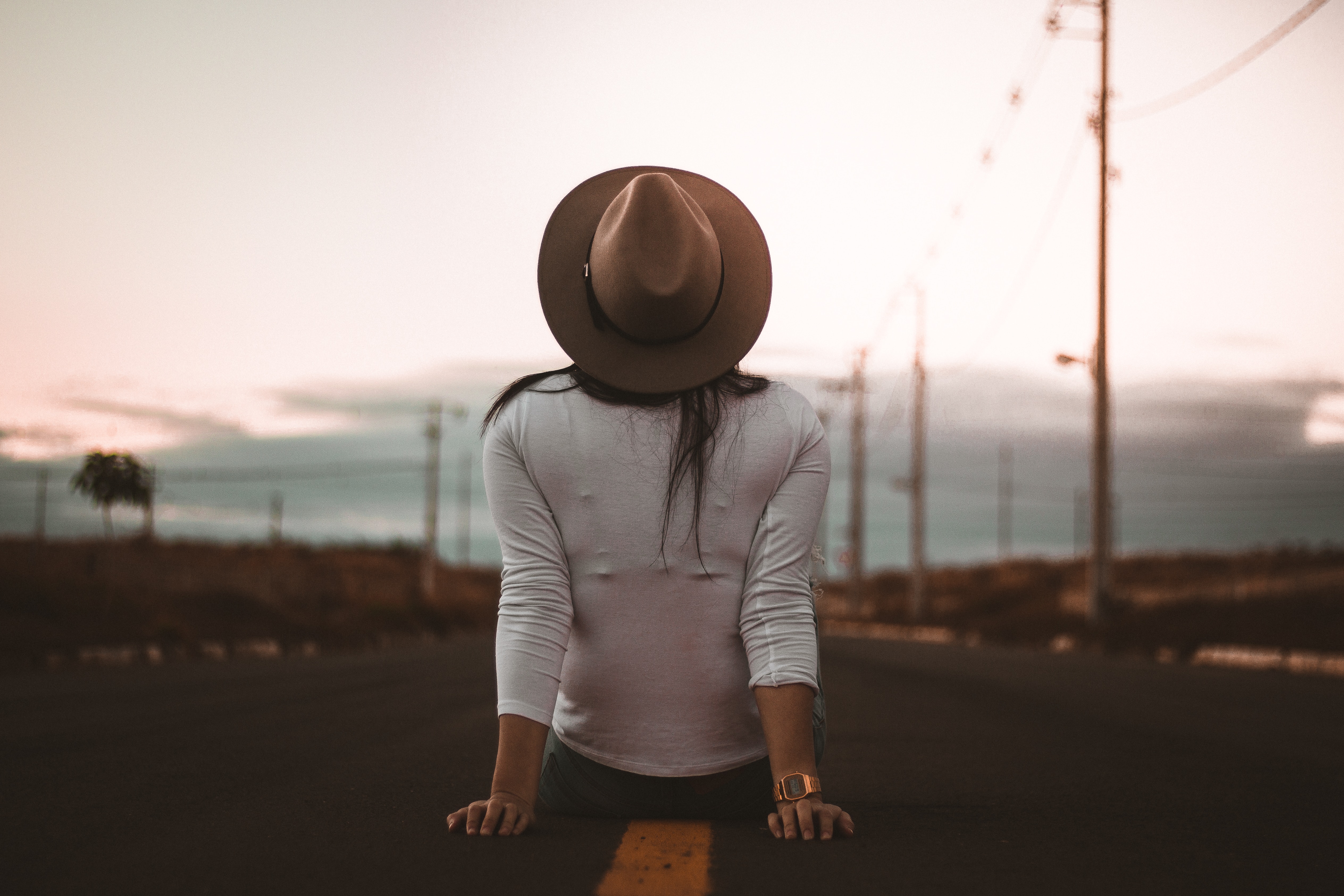 woman sitting in the middle of the road contemplating life