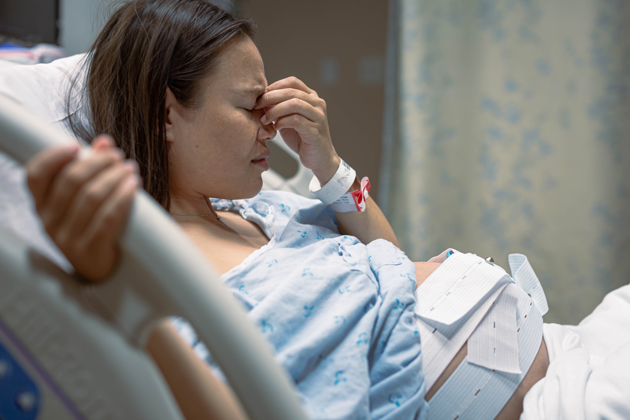 woman experiencing a migrain after giving birth