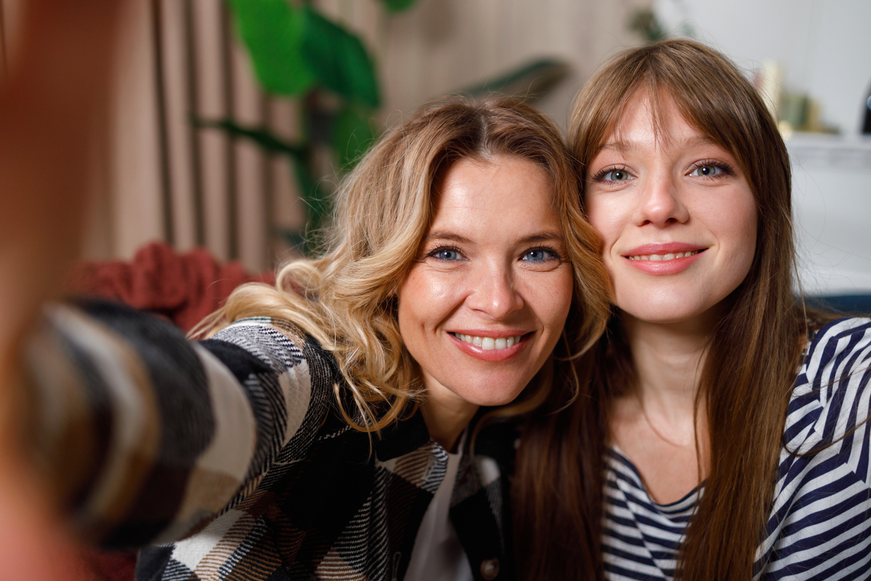 mom and daughter smiling at the camera