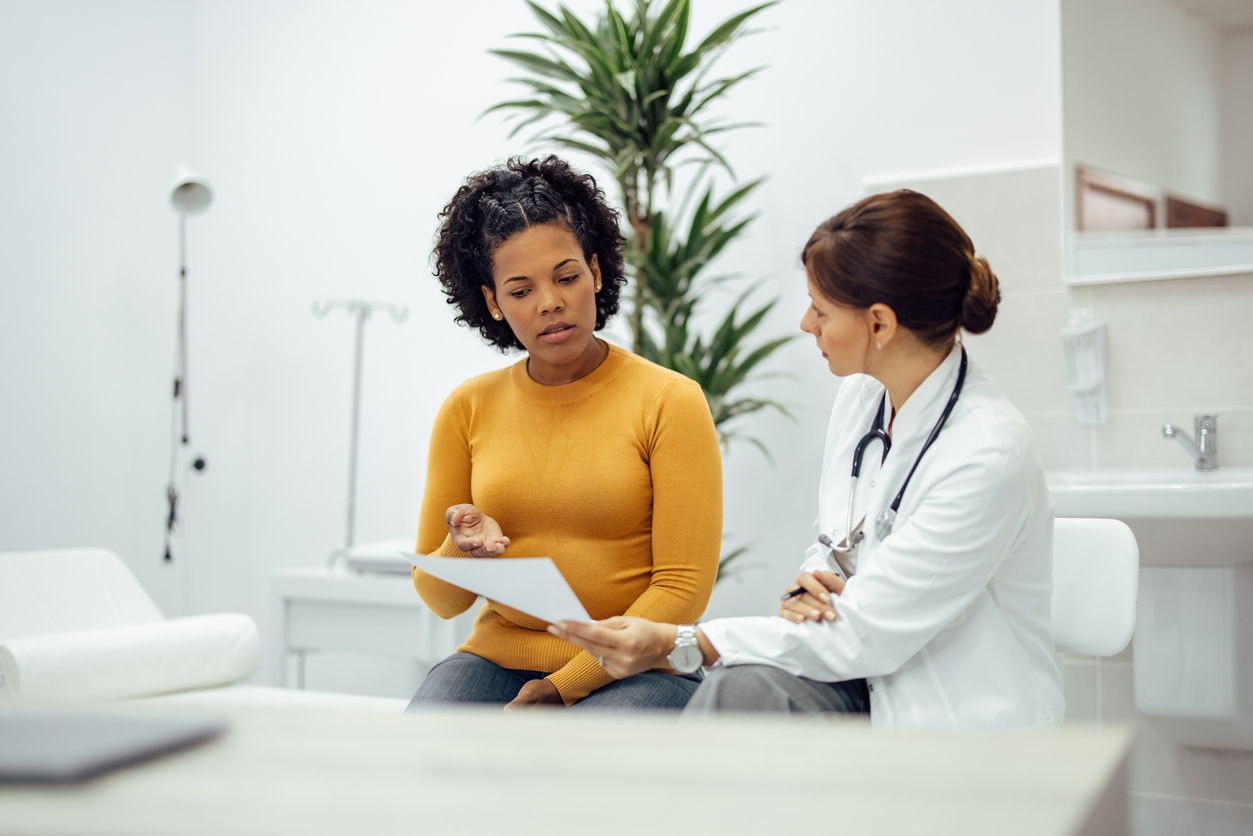 woman consulting with her doctor in a treatment room