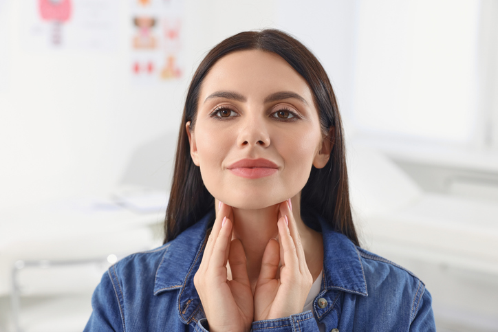 woman touching her neck