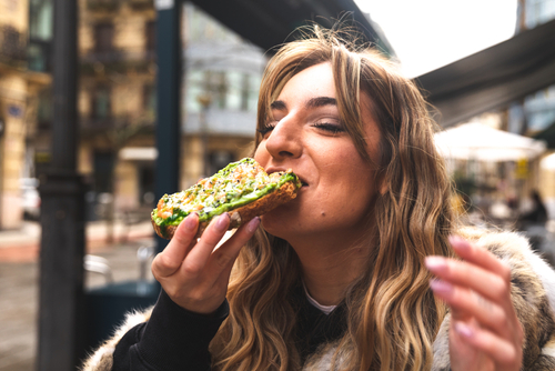 woman eating avocado toast