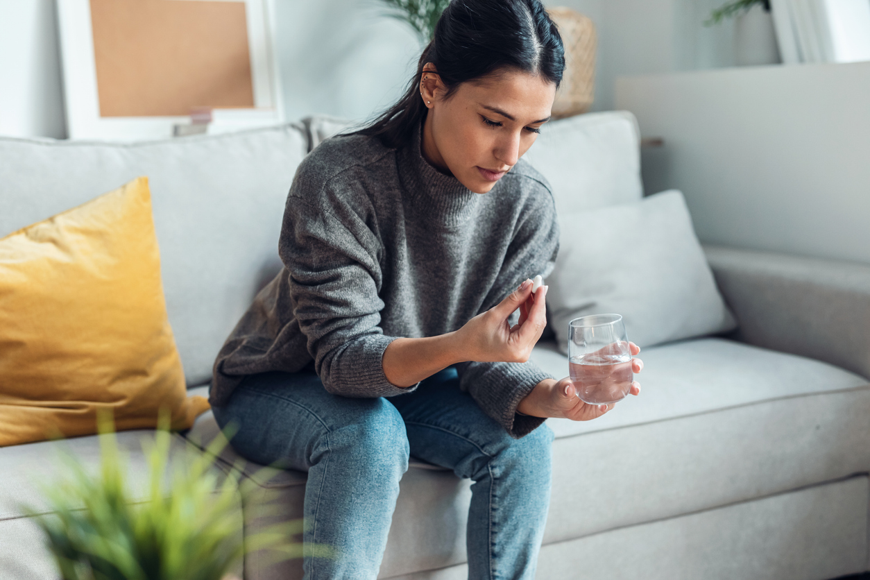 woman taking a pill