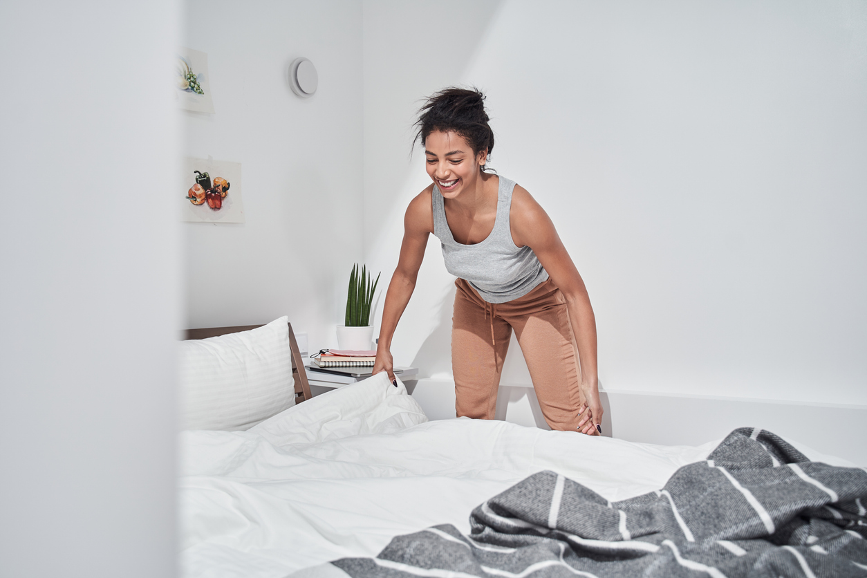 woman improving her bedding to manage sciatica