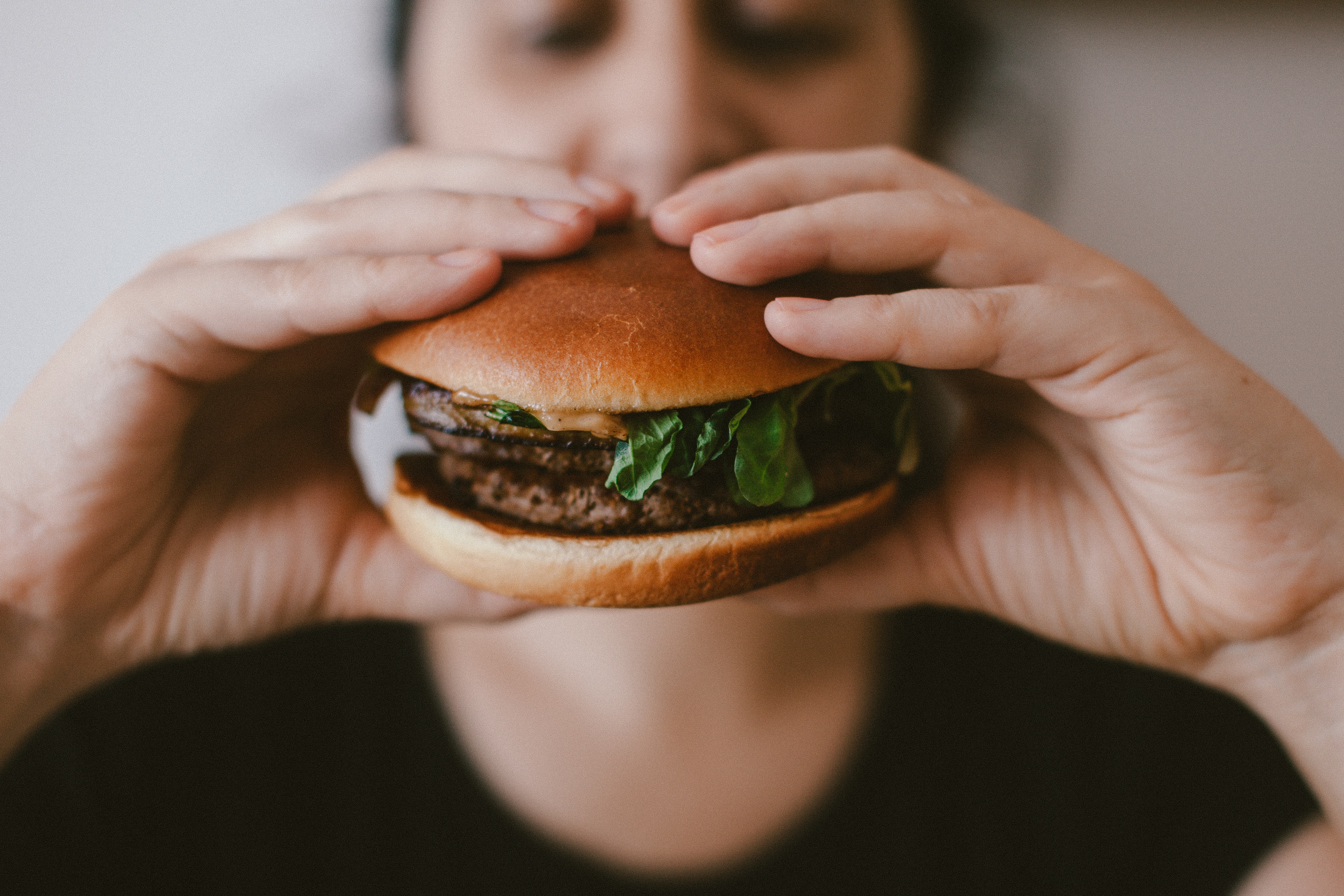 person eating a cheeseburger