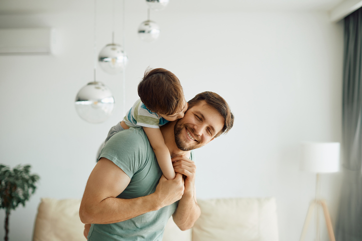 happy dad with son on his back