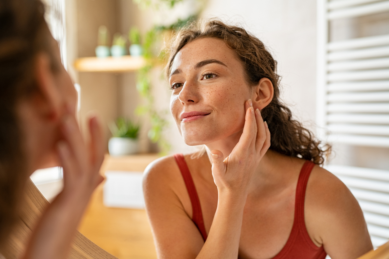 woman admiring her skin