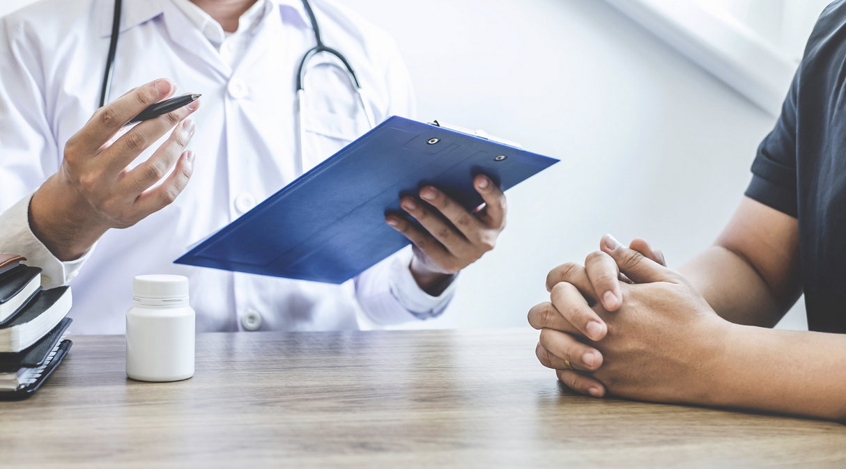 doctor with a clipboard meeting with a patient