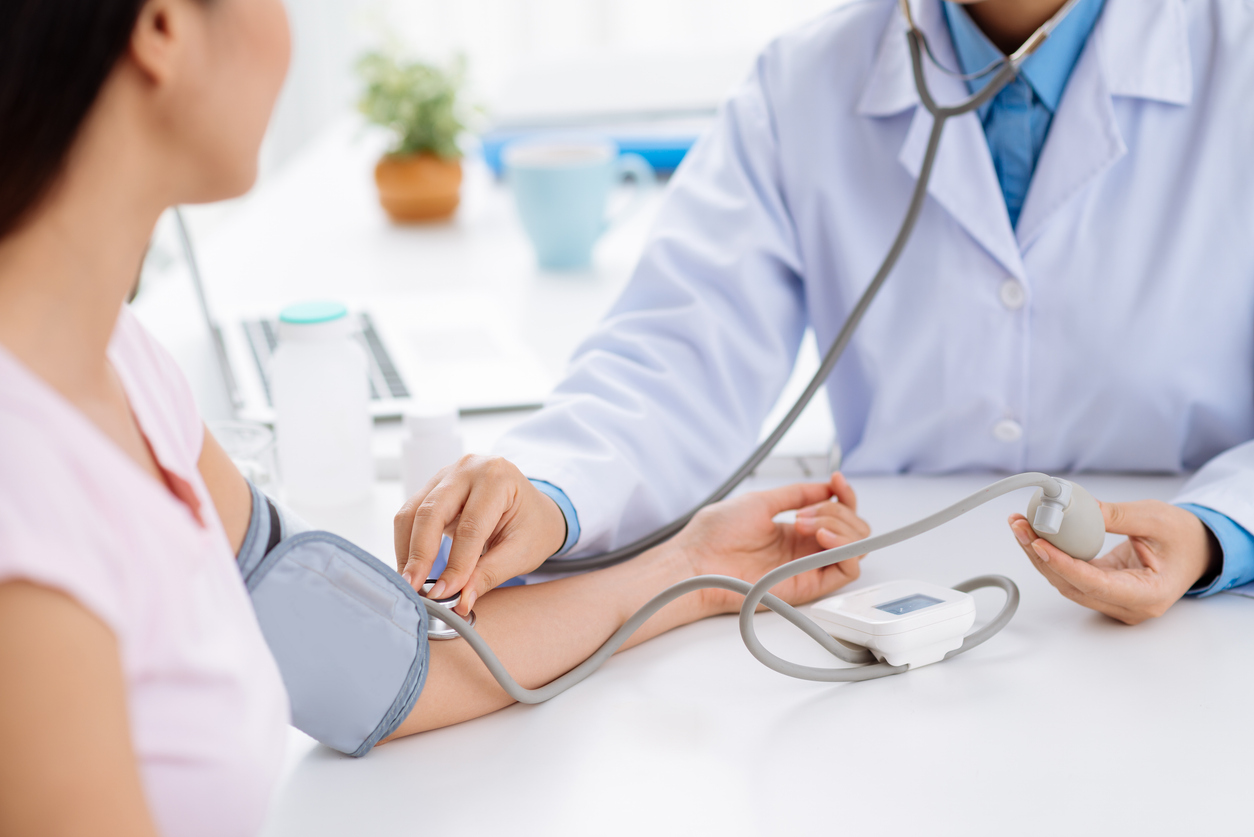 doctor taking a patient's blood pressure